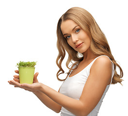 Image showing woman with green grass in pot