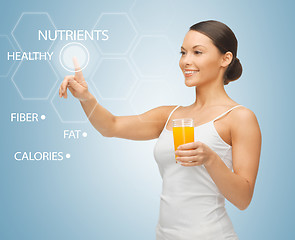Image showing woman with glass of juice and virtual screen