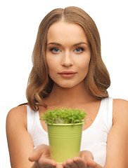 Image showing woman with green grass in pot