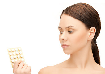 Image showing young woman with pills