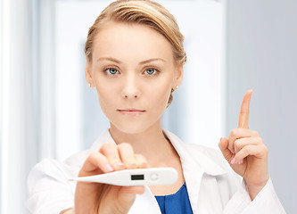 Image showing attractive female doctor with thermometer