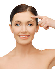 Image showing beautiful woman pointing to forehead