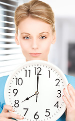 Image showing woman holding big clock