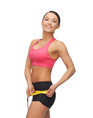 Image showing sporty woman with measuring tape