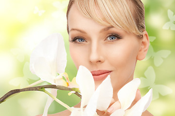 Image showing beautiful woman with orchid flower and butterflies