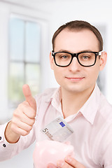 Image showing businessman with piggy bank and money