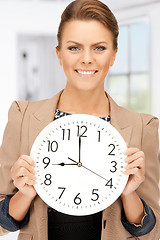 Image showing woman holding big clock