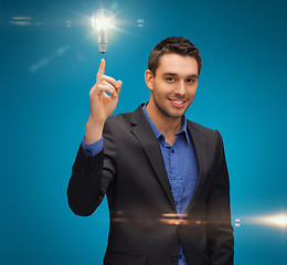 Image showing man in suit with light bulb