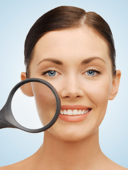 Image showing woman with magnifying glass over acne