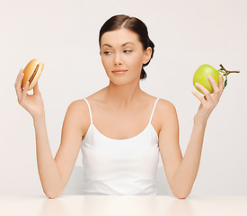 Image showing woman with hamburger and apple