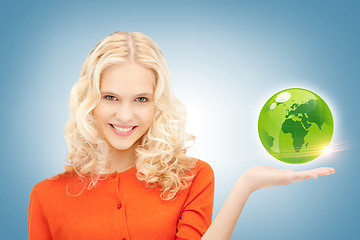Image showing woman holding green globe on her hand