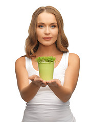 Image showing woman with green grass in pot