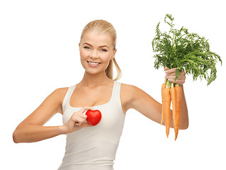 Image showing woman holding heart symbol and carrots