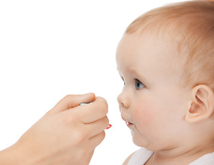 Image showing mother feeding adorable baby