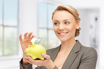 Image showing lovely woman with piggy bank and money