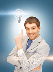 Image showing man in suit with light bulb