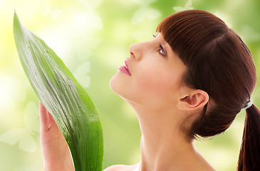 Image showing woman with green leaf and butterflies