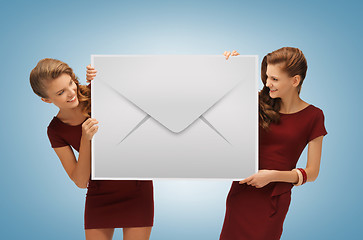 Image showing girls holding big envelope