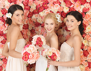 Image showing three women with background full of roses