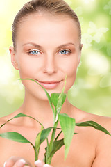 Image showing woman with sprout and butterflies