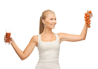 Image showing woman holding glass of juice and tomatoes