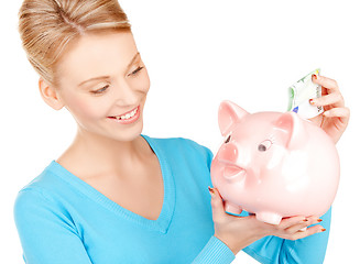 Image showing lovely woman with piggy bank and money