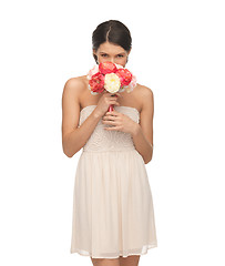 Image showing woman smelling bouquet of flowers