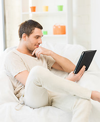 Image showing man sitting on the couch with tablet pc