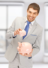 Image showing man with two piggy banks