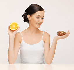 Image showing woman with cake and orange