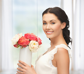 Image showing woman with vase of flowers