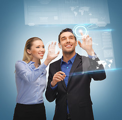 Image showing man and woman working with virtual touch screens