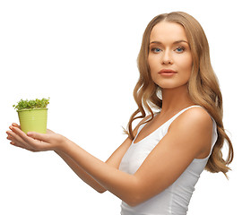 Image showing woman with green grass in pot