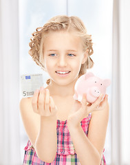 Image showing little girl with piggy bank and money