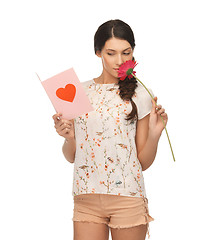 Image showing young woman holding flower and  postcard