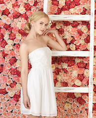 Image showing woman with old ladder and background full of roses