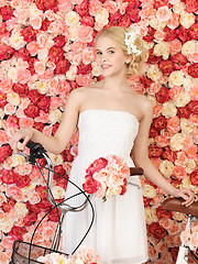 Image showing woman with bicycle and background full of roses