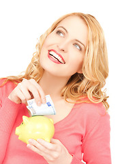 Image showing woman with piggy bank and cash money