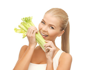 Image showing woman biting piece of celery or green salad