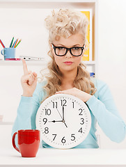 Image showing businesswoman with clock and finger up