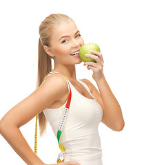 Image showing sporty woman with apple and measuring tape