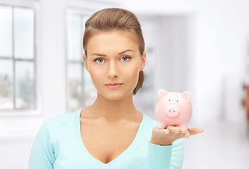 Image showing lovely woman with piggy bank