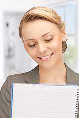 Image showing happy woman with big notepad