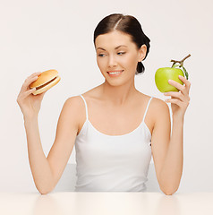 Image showing woman with hamburger and apple