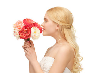 Image showing woman smelling bouquet of flowers