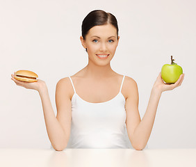 Image showing woman with hamburger and apple