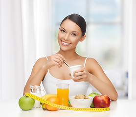 Image showing woman with healthy breakfast and measuring tape