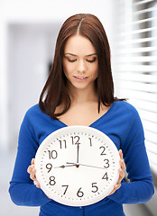 Image showing woman holding big clock