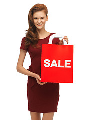 Image showing teenage girl in red dress with sale sign