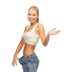 Image showing sporty woman showing big pants